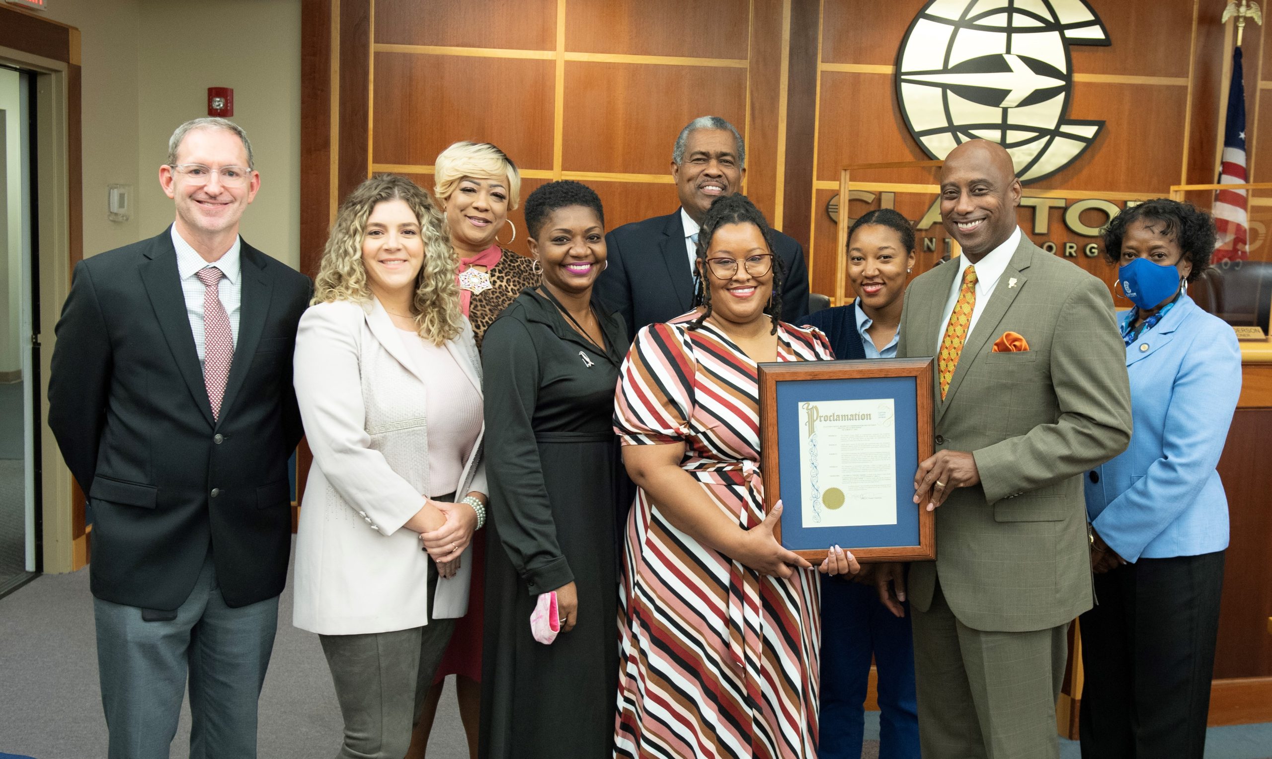Clayton County Commissioners and IT Staff holding framed proclamation